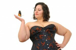 Young beautiful large woman with butterfly