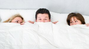 man lying with two girls